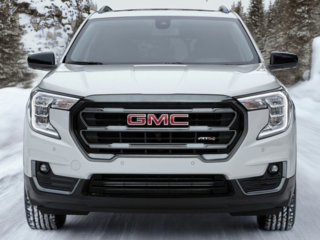 A white GMC Terrain driving outside