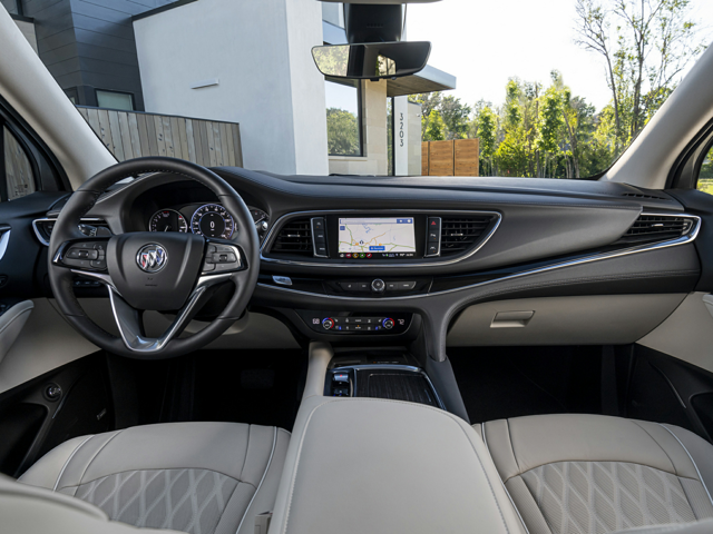 The front seat and steering wheel of a Buick vehicle
