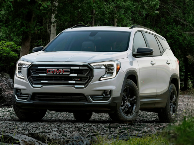 A white GMC Terrain parked outside