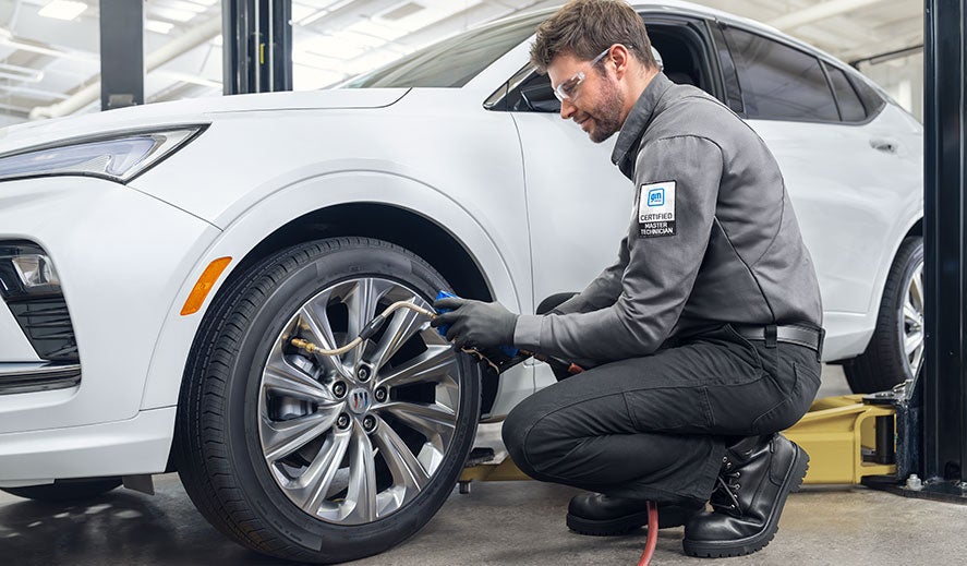 Buick Protection Service Expert Checking Tire